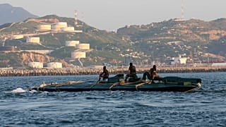 FILE: Navy sailors ride atop a 10-metre submarine packed with more than 5 tonnes of cocaine, as it is being towed into the port of Salina Cruz, Mexico, 18 July 2008