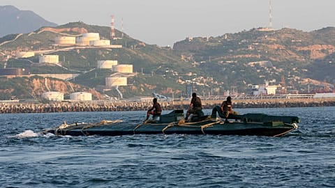 FILE: Navy sailors ride atop a 10-metre submarine packed with more than 5 tonnes of cocaine, as it is being towed into the port of Salina Cruz, Mexico, 18 July 2008