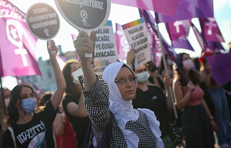Turkish women hold placards as they participate in a protest against the government's decision to withdraw from Istanbul Convention in Istanbul, 4 July, 2021