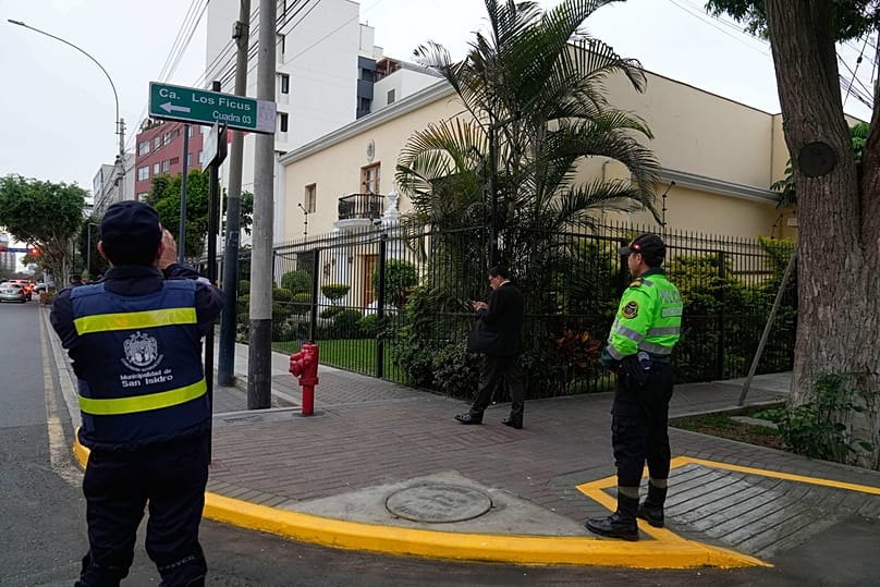 Police officer stands guard front of Mexico's embassy after Peruvian former Prime Minister Betssy Chavez enters asking for asylum, in Lima, Peru, Monday, Nov. 3, 2025.