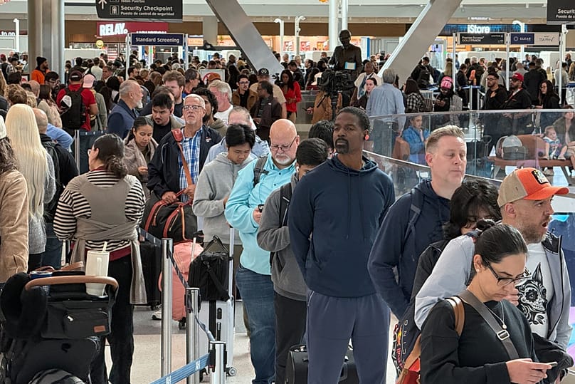 Travelers wait in long security lines at George Bush Intercontinental Airport, Monday, Nov. 3, 2025, in Houston. (AP Photo Lekan Oyekanmi)