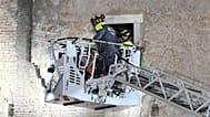 Firefighters pull a construction worker from under the debris of a medieval tower, which was under renovation near the Roman Forum in Rome, Monday, Nov. 3, 2025.