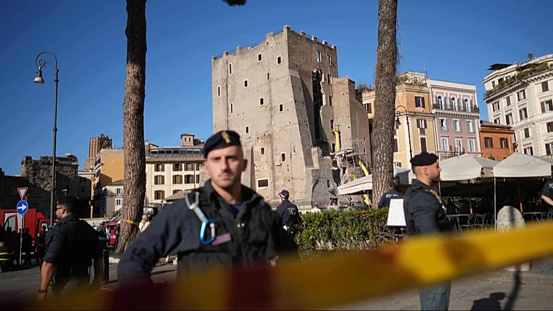 Police officers patrol the medieval tower Torre dei Conti area in Rome, Italy, Monday, Nov. 3, 2025.