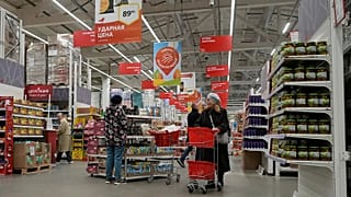 Customers choose food products in a store of the French retailer Auchan in St. Petersburg, 24 October, 2024
