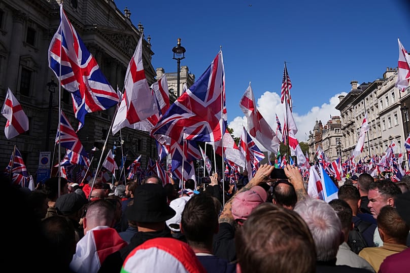 People demonstrate during the Tommy Robinson-led Unite the Kingdom march and rally in London, 13 September, 2025