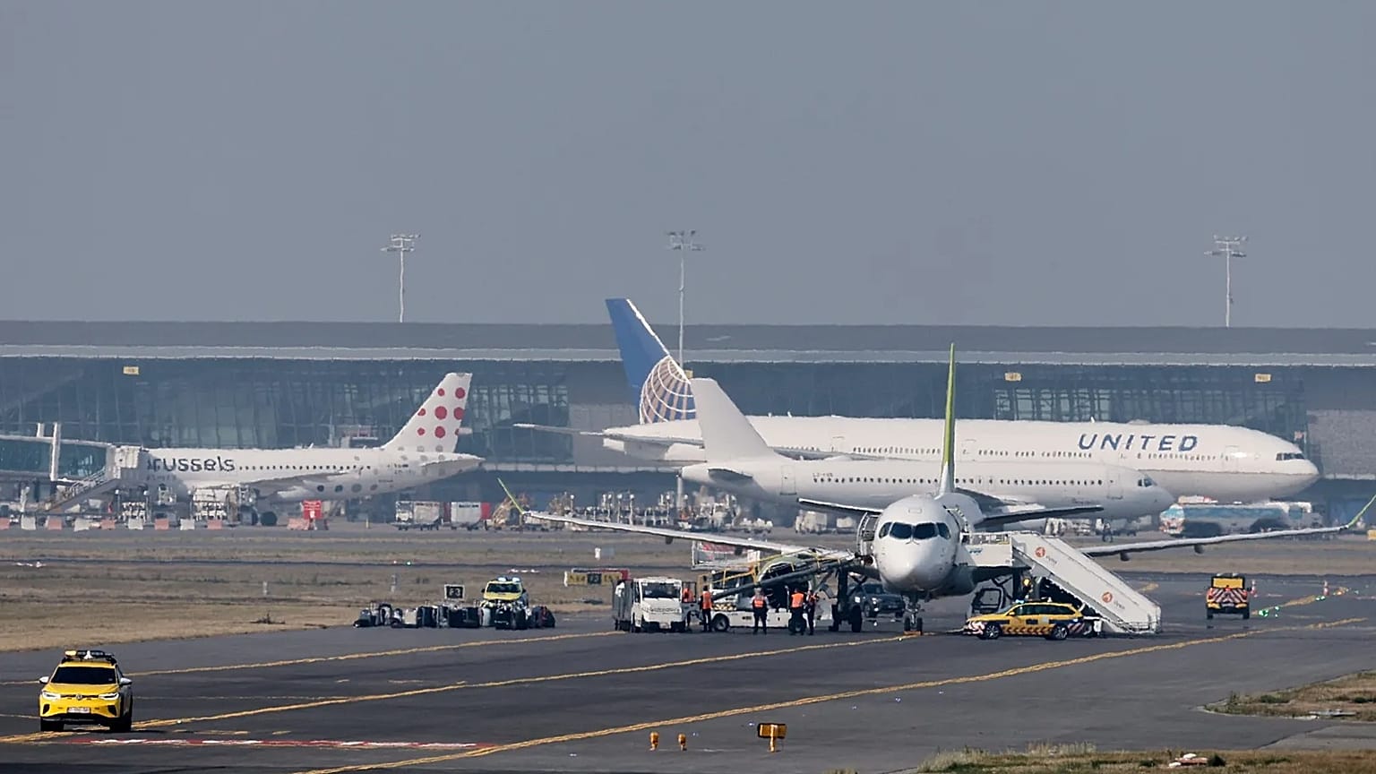 Security personnel search an aircraft on the tarmac at Brussels International Airport, 1 October, 2025
