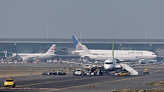 Security personnel search an aircraft on the tarmac at Brussels International Airport, 1 October, 2025