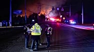 Members of law enforcement wear respirators near the area of the reported plane crash at Louisville Muhammad Ali International Airport, in Louisville, KY, 4 November 2025