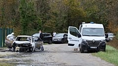 Investigators inspect the burned car after a motorist deliberately rammed pedestrians and cyclists across two neighbouring towns on Île d’Oléron, 5 November, 2025 