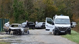 Investigators inspect the burned car after a motorist deliberately rammed pedestrians and cyclists across two neighbouring towns on Île d’Oléron, 5 November, 2025 