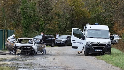 Investigators inspect the burned car after a motorist deliberately rammed pedestrians and cyclists across two neighbouring towns on Île d’Oléron, 5 November, 2025 