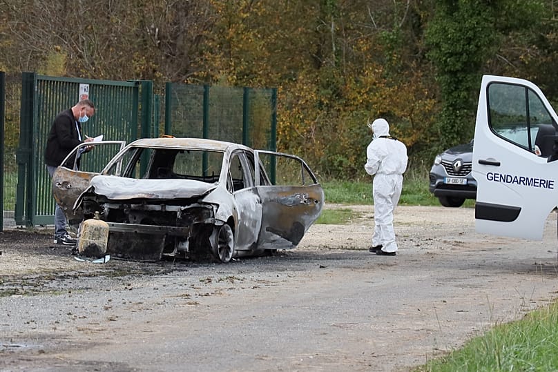 Investigators inspect the burned car after a motorist deliberately rammed pedestrians and cyclists across two neighbouring towns on the Île d’Oléron, 5 November, 2025