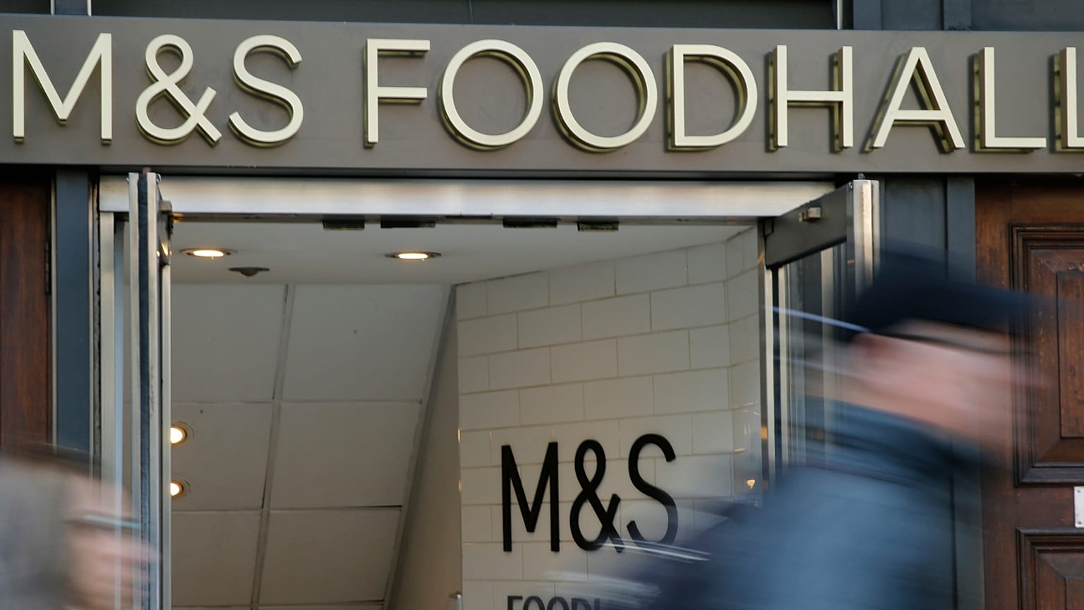 People walk past a branch of British clothing and food store Marks and Spencer in London. 23 May 2018.