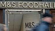 People walk past a branch of British clothing and food store Marks and Spencer in London. 23 May 2018.