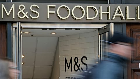 People walk past a branch of British clothing and food store Marks and Spencer in London. 23 May 2018.