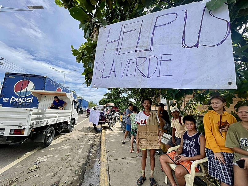 Residents of Isla Verde call for help as they return to their damaged homes after Typhoon Kalmaegi Talisay City, Cebu province, central Philippines, Wednesday, Nov. 5, 2025.