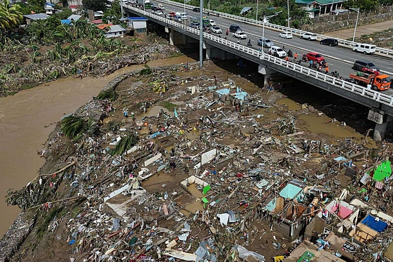 Residents return to what remains of their homes after Typhoon Kalmaegi caused devastation in communities along the Mananga River in Talisay City, Cebu province, central Philip
