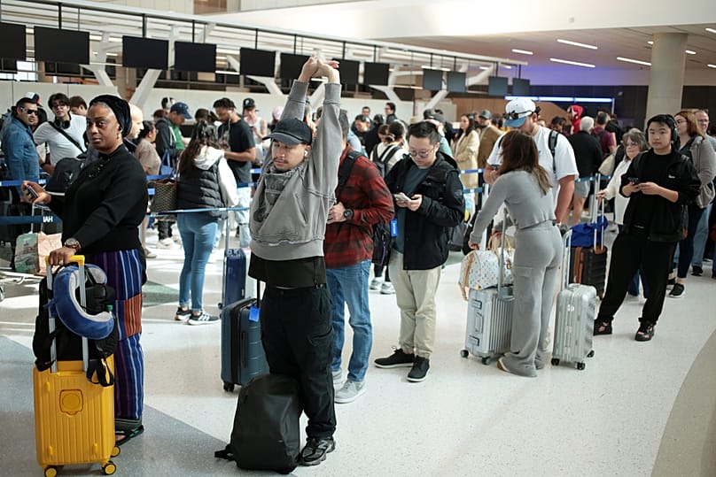 Travelers wait in long security lines at George Bush Intercontinental Airport, Monday, Nov. 3, 2025, in Houston. (AP Photo Lekan Oyekanmi)
