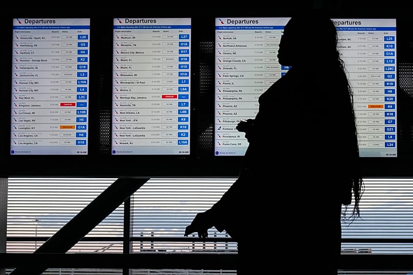 A traveler walks through the skyway leading to terminal 3 at O'Hare International Airport in Chicago, Monday, Nov. 3, 2025.