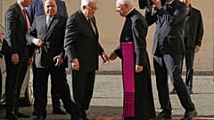 Mahmúd Abbász palesztin elnököt (balra) Leonardo Sapienza monszinyor fogadja érkezésekor a vatikáni San Damaso udvarán.