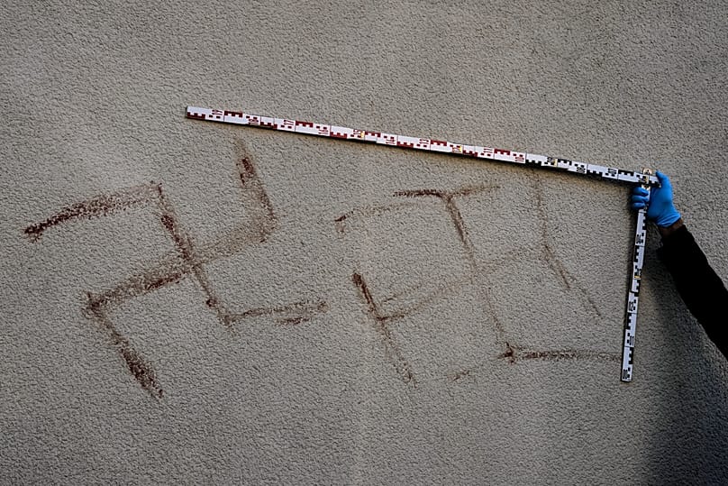 Criminal experts measure swastikas at a house in Hanau, 6 November, 2025