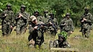 Volunteers in Poland's army practice shooting during training exercises in Nowogrod, 20 June, 2024