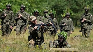 Volunteers in Poland's army practice shooting during training exercises in Nowogrod, 20 June, 2024
