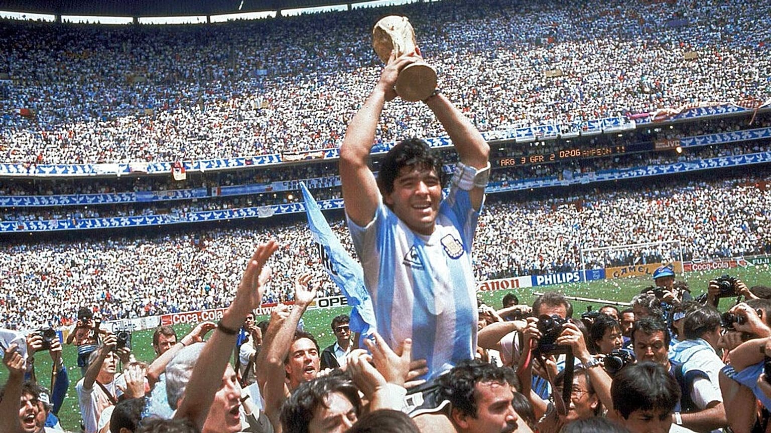 Diego Maradona holds up his team's trophy after Argentina's 3-2 victory over West Germany at the World Cup final match, 29 June 1986