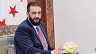 Syria's interim President Ahmad al-Sharaa receives the final version of the provisional electoral system for the People's Assembly, in Damascus, 27 July 2025