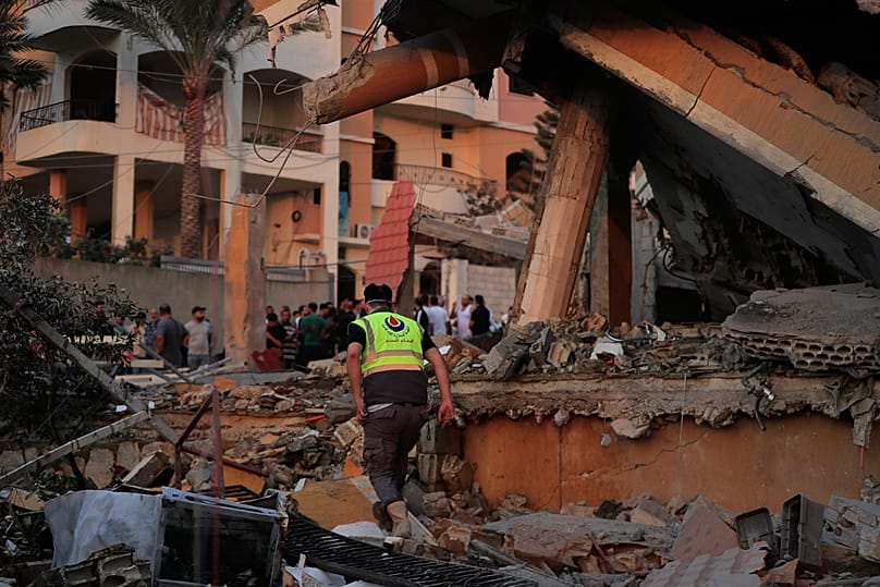 A civil defense member inspects the rubble of a building destroyed by an Israeli airstrike in the village of Teir Debba, southern Lebanon, Thursday, Nov. 6, 2025.