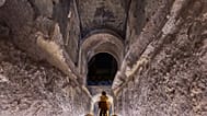 A journalist scans the 'Commodus Passage' built underneath the Colosseum in Rome, Tuesday, Oct. 21, 2025.