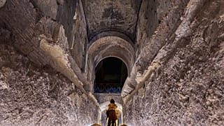 A journalist scans the 'Commodus Passage' built underneath the Colosseum in Rome, Tuesday, Oct. 21, 2025.