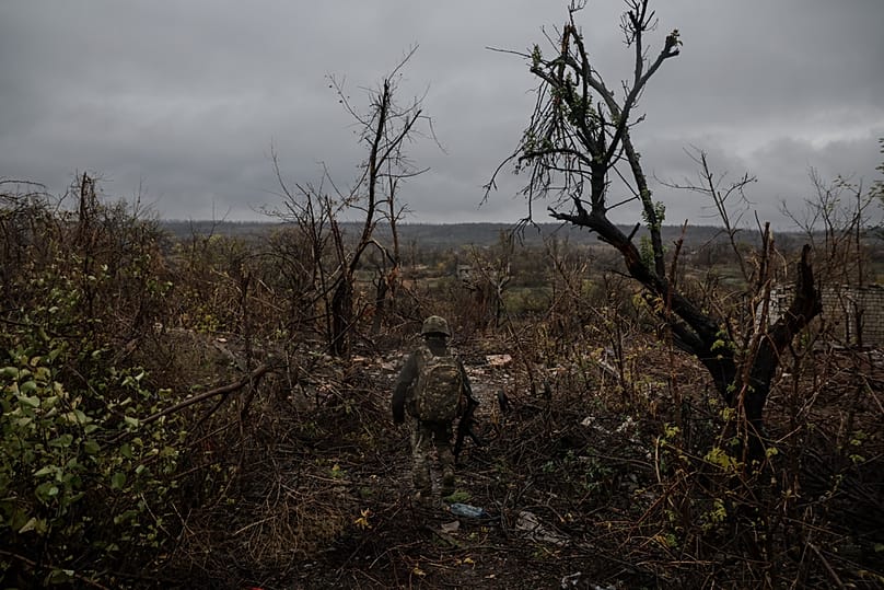 In this photo provided by a Ukrainian army press service, a Ukrainian serviceman walks near the frontline town of Chasiv Yar in Donetsk region, Ukraine, Oct. 25, 2025. 