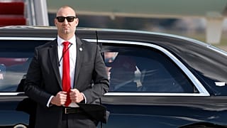 يقف عميل من جهاز الخدمة السرية الأمريكي بجوار سيارة الرئيس دونالد ترامب، المعروفة باسم "الوحش"، قاعدة أندروز المشتركة بولاية ماريلاند، الخميس 30 أكتوبر/تشرين الأول 2025،