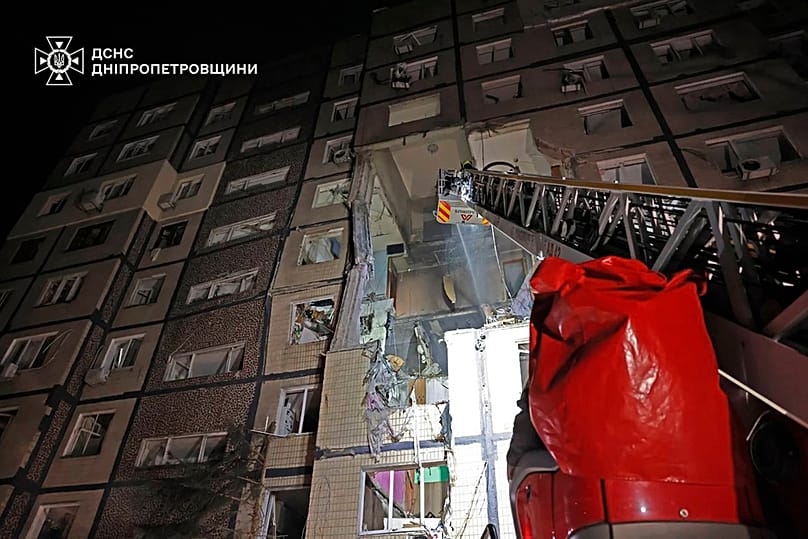 firefighters put out the fire following a Russian rocket attack that hit a multi-storey apartment building in Dnipro, Ukraine, Saturday, Nov. 8, 2025