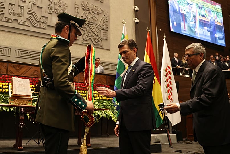 President Rodrigo Paz, right, receives the presidential sash from Vice President Edman Lara in La Paz, Bolivia, Saturday, Nov. 8, 2025