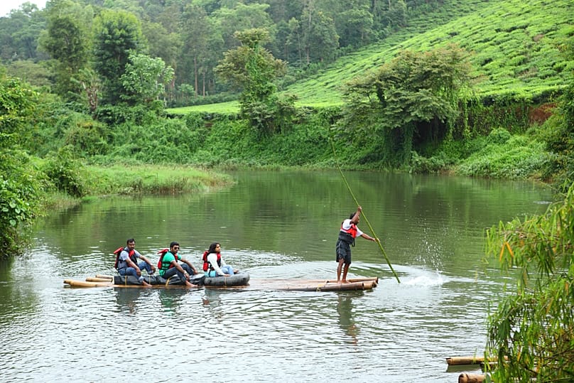 Visitors gliding through the tranquil backwaters of Pozhuthana, Wayanad, KL, India. 