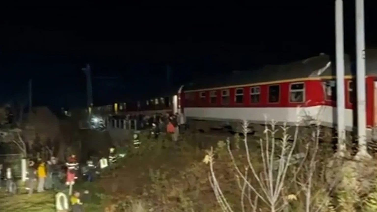 In this image made from video provided by Slovakia's Fire Service, passengers are guided by emergency services after a train crash in Pezinok, 9 November 2025.
