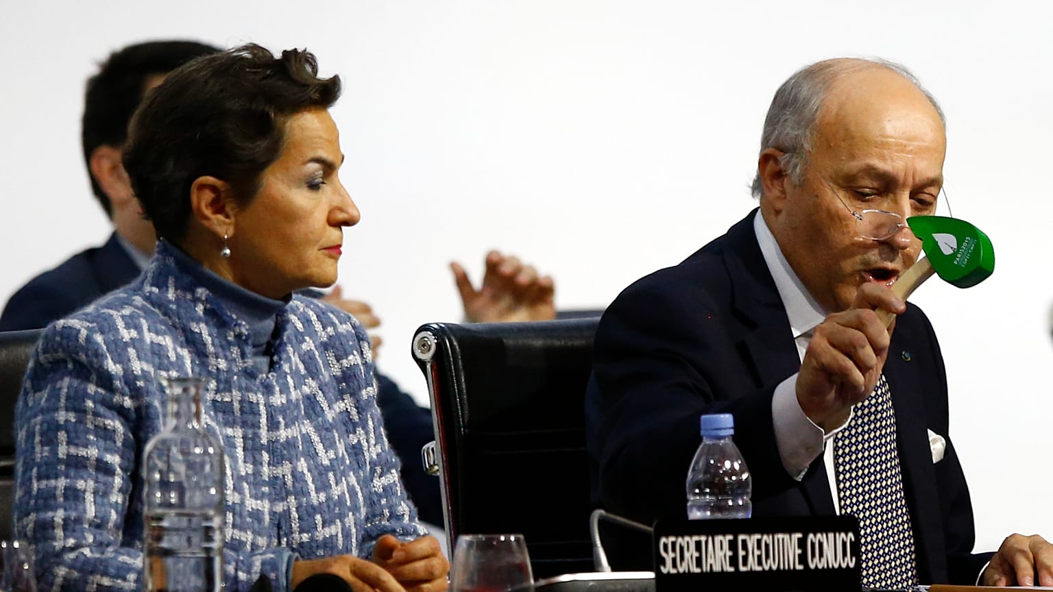 President of COP21 Laurent Fabius uses to hammer to mark the adoption of the Paris Agreement while United Nations climate chief Christiana Figueres looks on at COP21 in 2015.