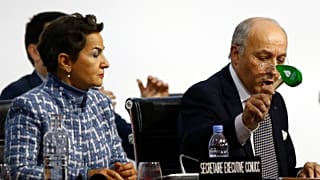 President of COP21 Laurent Fabius uses to hammer to mark the adoption of the Paris Agreement while United Nations climate chief Christiana Figueres looks on at COP21 in 2015.