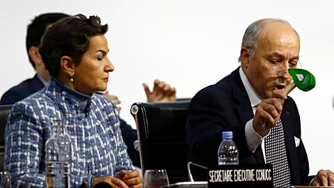 President of COP21 Laurent Fabius uses to hammer to mark the adoption of the Paris Agreement while United Nations climate chief Christiana Figueres looks on at COP21 in 2015.