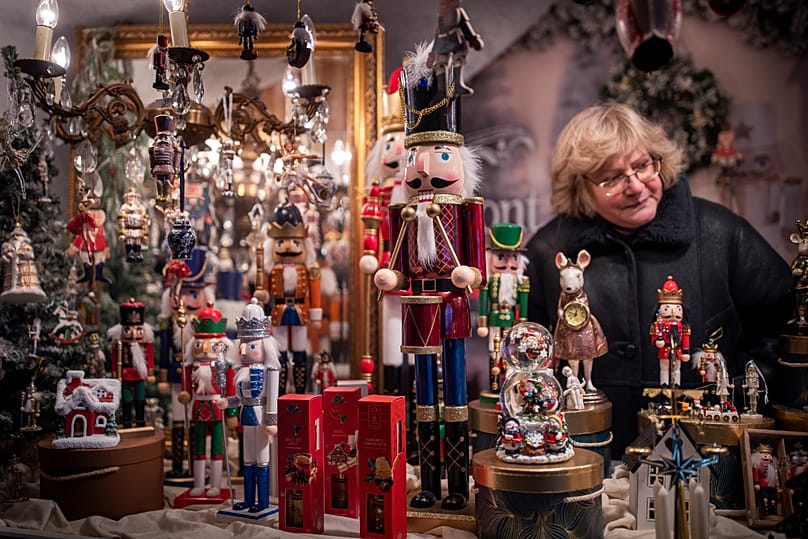 A woman sells a toys at a Christmas market at Cathedral Square in Vilnius, Lithuania