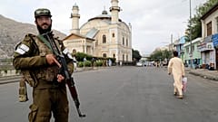 FILE: A Taliban fighter stands guard as Afghan people attend Eid al-Adha prayers, in Kabul, 28 June 2023