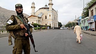 FILE: A Taliban fighter stands guard as Afghan people attend Eid al-Adha prayers, in Kabul, 28 June 2023
