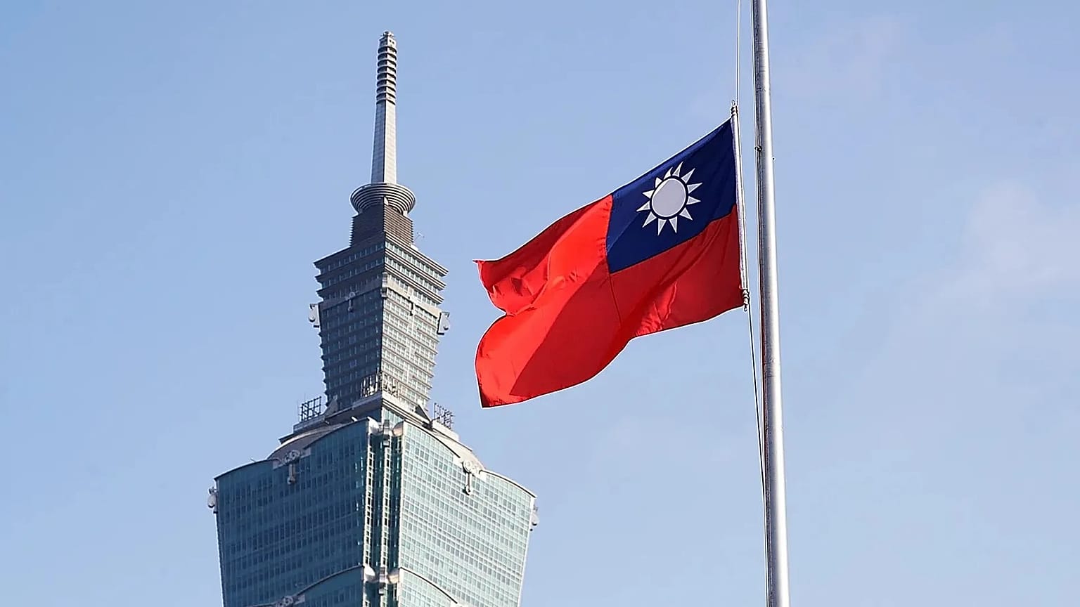 A Taiwan national flag flutters near the Taipei 101 building at the National Sun Yat-Sen Memorial Hall in Taipei, 28 February, 2025