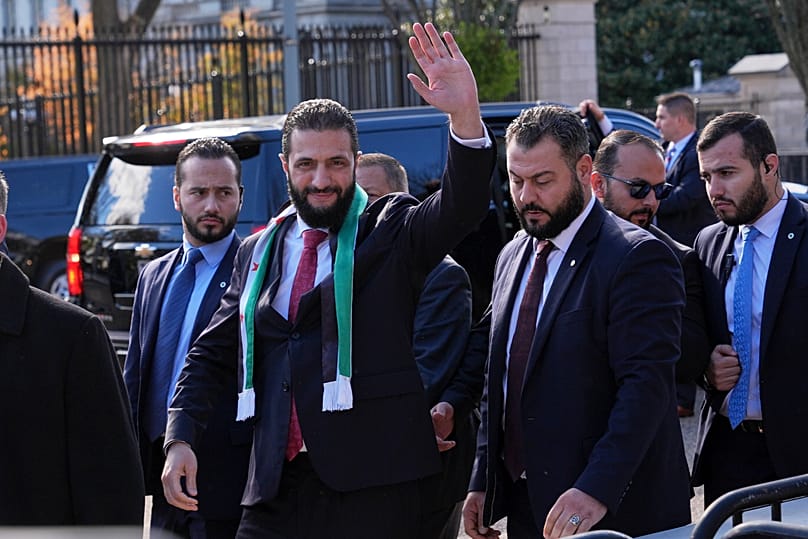 Syria's President Ahmad al-Sharaa waves as he greets supporters outside of the White House, Monday, Nov. 10, 2025, in Washington, following a meeting with President Trump.
