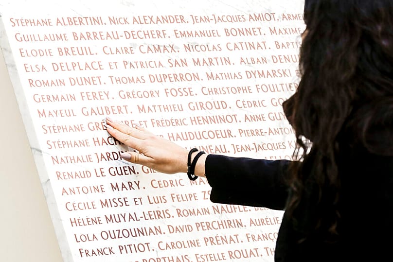 People pay their respect to the victims of the terror attacks of Nov.13, 2015 at the Bataclan Concert Hall in which 130 people were killed ,Sunday, Nov.13 2022 in Paris 