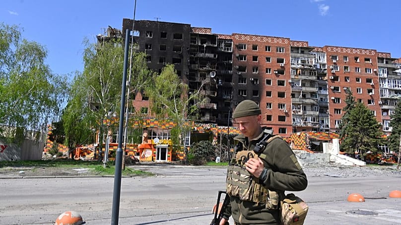 FILE - A Ukrainian soldier walks past damaged buildings in central Pokrovsk, in the Donetsk region of Ukraine, April 23, 2025