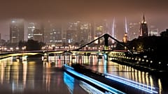 Long exposure photo shows a cargo ship on the river Main in Frankfurt, Germany, on a foggy, Sunday