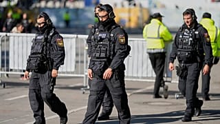 FILE: German police officers walk through the Oktoberfest, which remains closed after a bomb threat in Munich, Germany, Wednesday, Oct. 1, 2025.